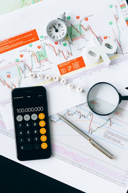 pexels photo 6120182 6120182 Flat lay of charts, calculator, and magnifying glass on office desk for market analysis.